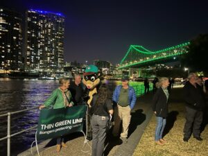 Herbie and Rangers from the Queensland Ranger Association on World Ranger Day lighting up the Story Bridge green.